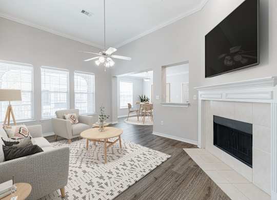 A living room with a grey couch, a coffee table, and a fireplace.