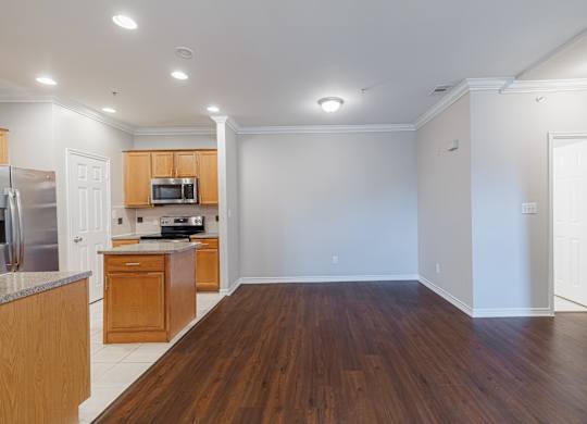 A kitchen with wooden cabinets and a refrigerator.