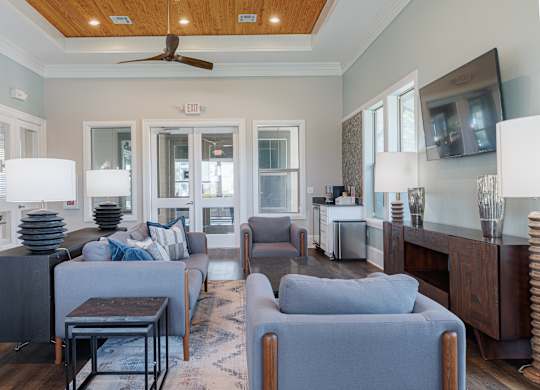 A living room with a grey couch and a wooden table.