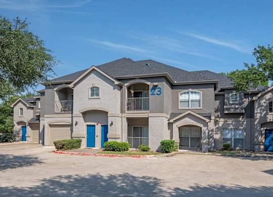 A large, modern house with the number 23 on the front.