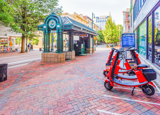 a red scooter parked in front of a store