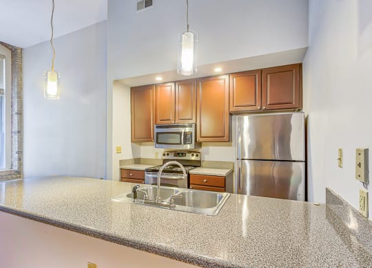 a kitchen with granite countertops and stainless steel appliances
