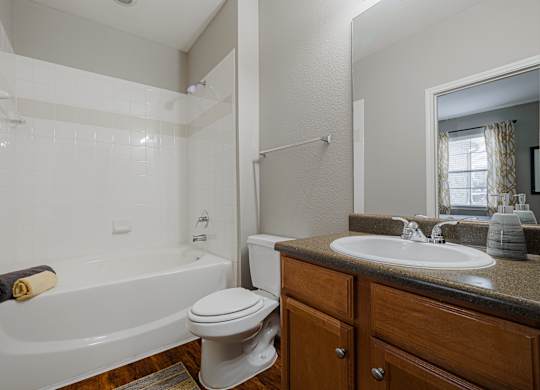 a bathroom with a sink toilet and bath tub