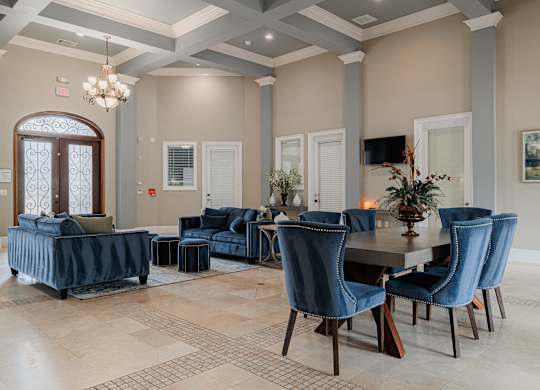 a dining room and living room with blue chairs and a table