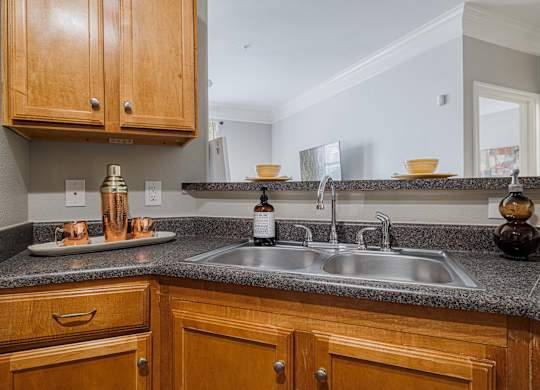 a kitchen with a sink and wooden cabinets