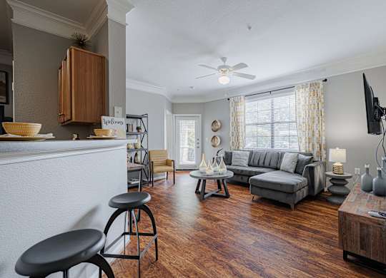 an open living room with furniture and a large window
