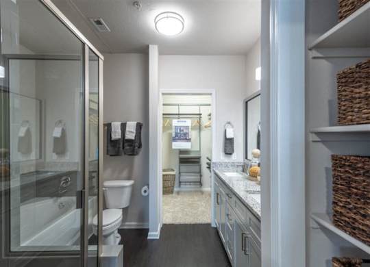 a bathroom with a shower and a toilet and a sink