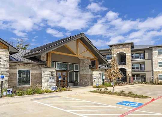 A building with a parking lot in front of it.