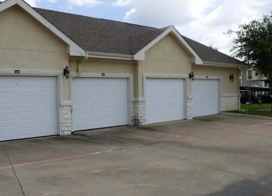 a house with three garage doors and a driveway