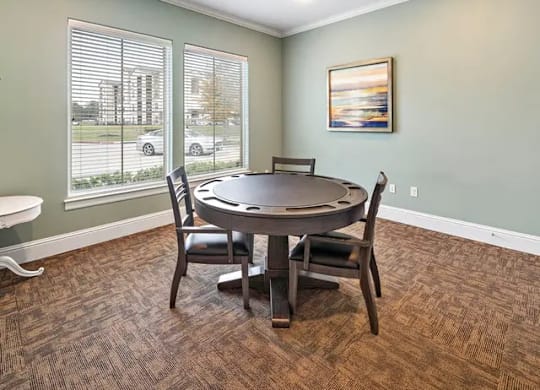 A dining room with a round table and chairs.