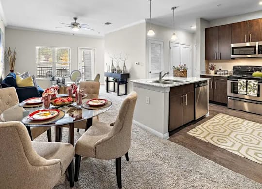A modern kitchen with a dining table set for four.