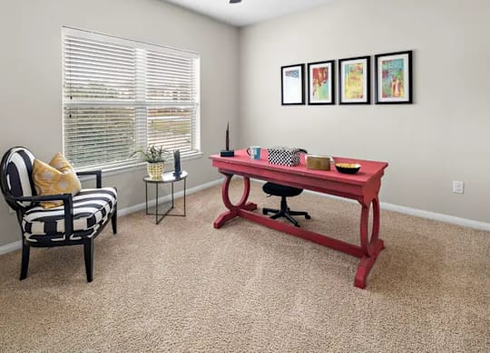 A room with a red table and a black and white chair.