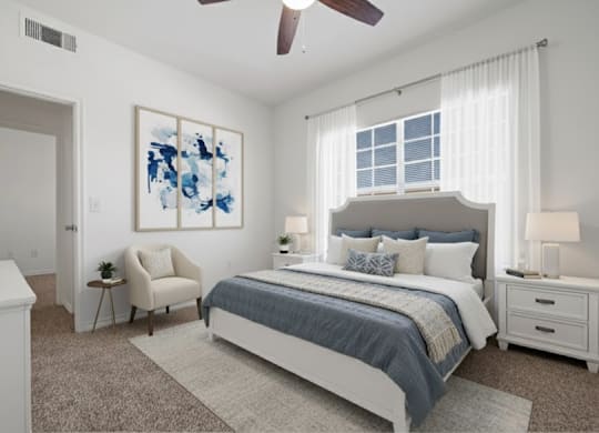 A bedroom with a large bed, a chair, and a painting on the wall.