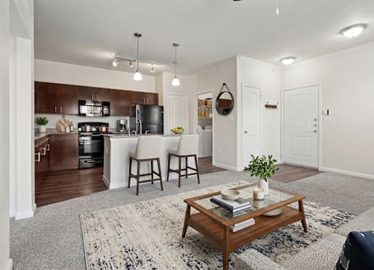A modern kitchen with a dining area and a living room.