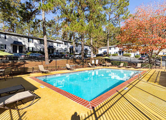 a resort style pool with chairs around it