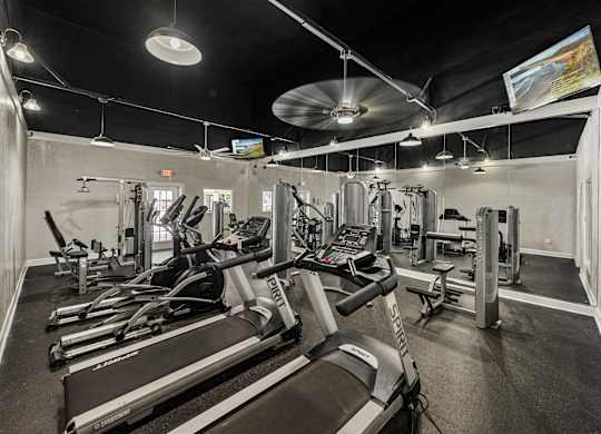 A gym with treadmills and other exercise equipment.
