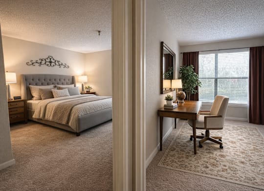 A bedroom with a bed, desk, and chair.