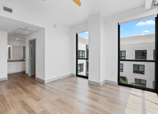 an empty room with purple and white walls and a wood floor