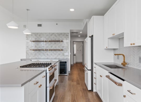 a large white kitchen with white cabinets and white counter tops and a wood floor