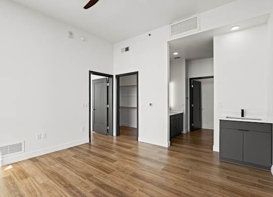 A room with a wooden floor and white walls.