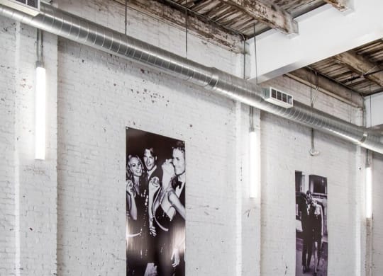 a black and white photo of the beatles on a brick wall
