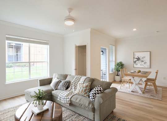 A living room with a grey couch and a coffee table.