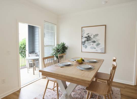 A dining room with a table set for two.