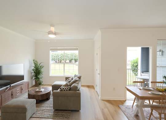 A living room with a television, couch, and a table.