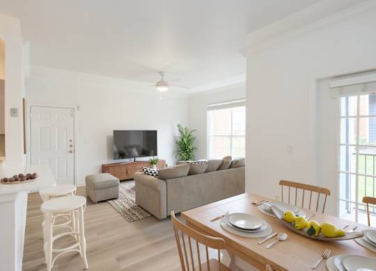 A dining room with a table set for a meal.