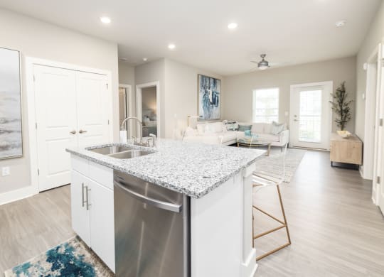 a white kitchen with a stainless steel dishwasher