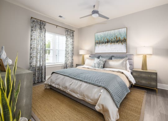 a bedroom with a bed and a ceiling fan