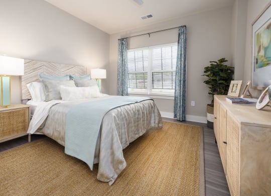 a bedroom with a large bed and a window