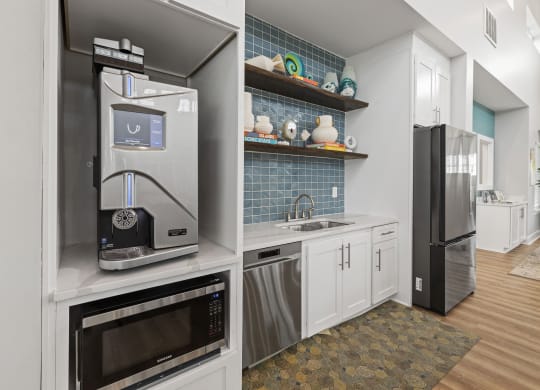 a kitchen with white cabinets and stainless steel appliances and a refrigerator