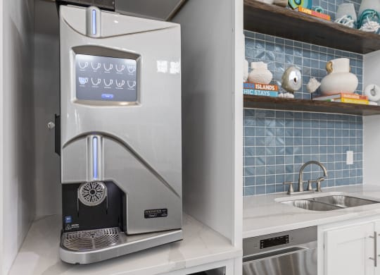 a small kitchen with a coffee machine and a sink