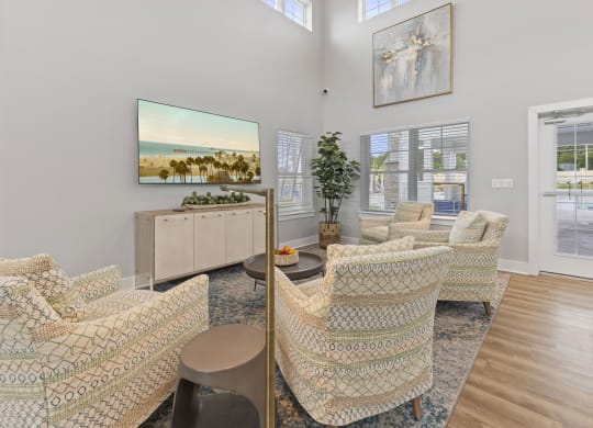 the living room of a house with chairs and a table
