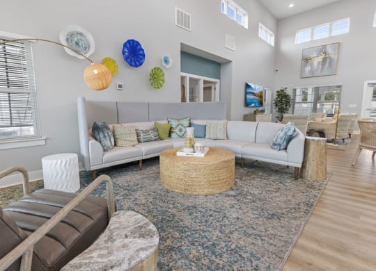 a living room with couches and chairs and a rug