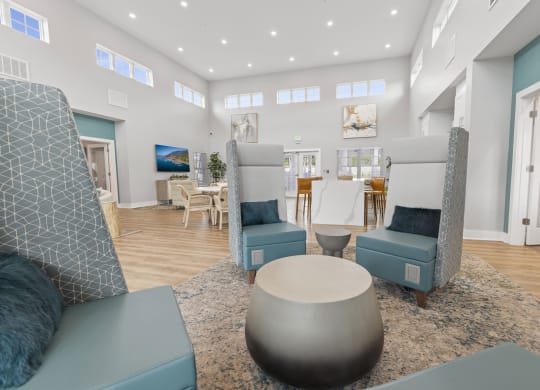a living room with blue chairs and a coffee table