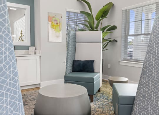 a living room with a chair and and other furniture and a window