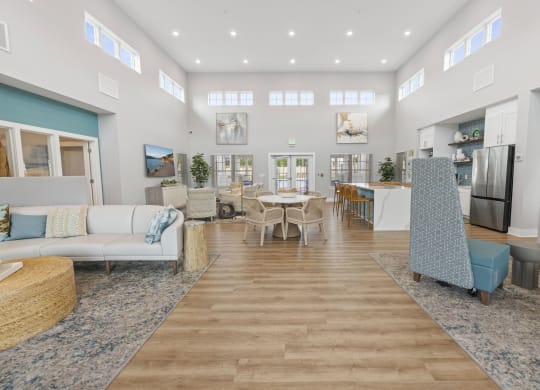 a living room with couches and a dining room with a table