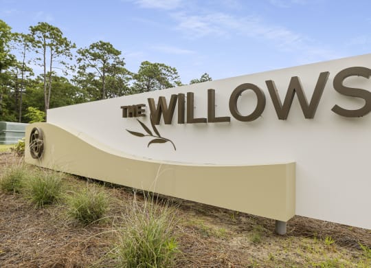 a sign for the willows at the entrance of the company headquarters