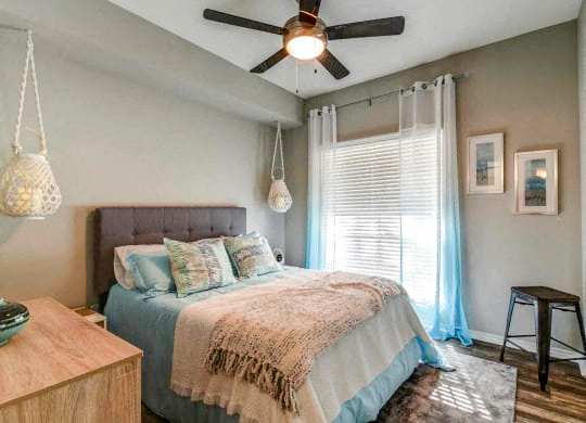 a bedroom with a bed and a ceiling fan