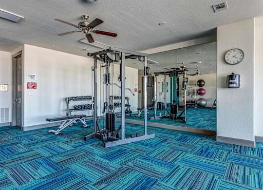 a fitness center with weights machines and mirrors