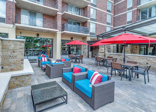 A patio with a stone fireplace and furniture.