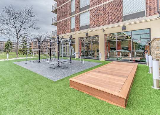 A backyard with a wooden deck and a playground.