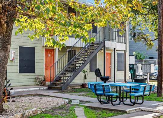 our apartments have a patio with a table and chairs