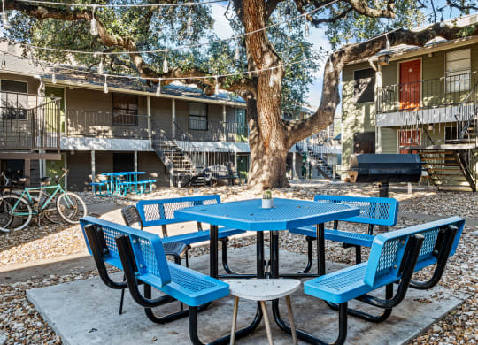 our yard is full of tables and chairs and a grill