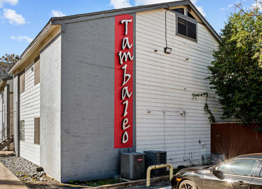 a white building with a red sign on the side of it
