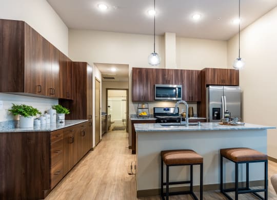 Apartment kitchen with modern pendant lights at Brownstone, Las Vegas