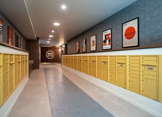 Mail room with brass mailboxes and modern artwork at Montage Apartments, Tigard, OR