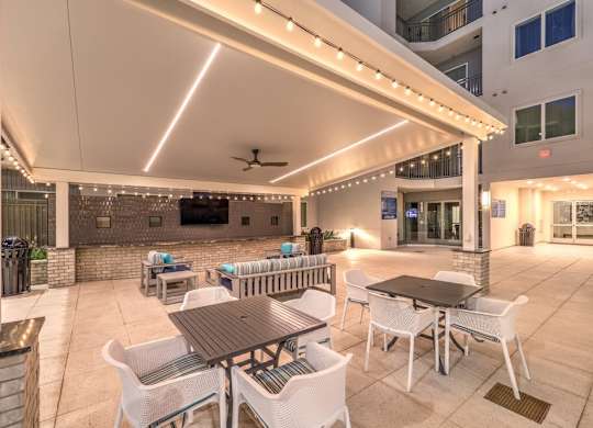 A patio with a table and chairs under a canopy.